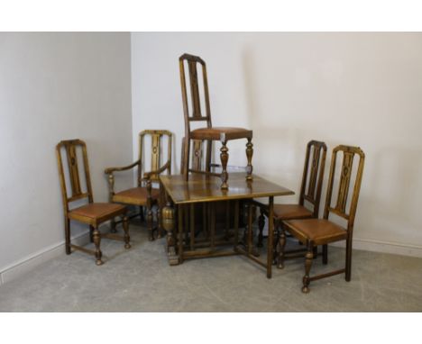 A 1940's oak drop-leaf gate-leg table with bulbous cup and cover supports 70cm x 90cm x 39cm (closed) and six oak dining chai