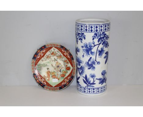 A Japanese Imari plate with figural scene 31cm and a Chinese design blue and white cylindrical stick stand, decorated with bl