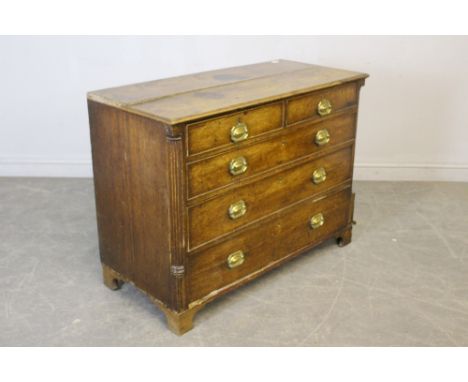 A George III oak chest of drawers, the moulded rectangular top above two short and three ling cockbeaded drawers, each with c