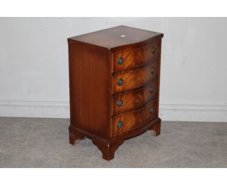 A reproduction mahogany chest of drawers, the serpentine fronted top above four cockbeaded drawers, on bracket feet 69cm x 48