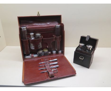 A good quality light tan fitted leather travel case with contents of assorted bottles, tidies and manicure pieces, 24cm tall 
