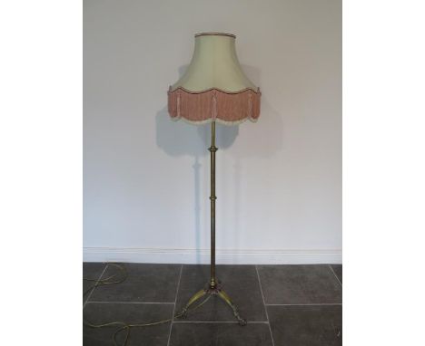 A brass adjustable standard lamp with shade extends to 211cm, in working order 