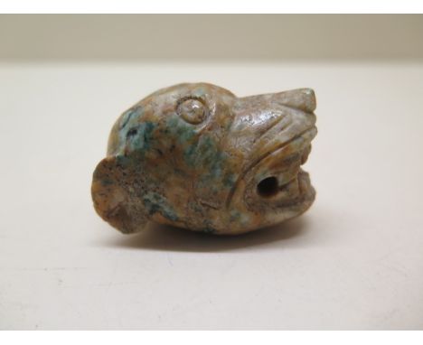 A Chinese 10th / 12th century jade carving of a tigers head pendant, 5cm x 3cm, some surface wear otherwise good for age 