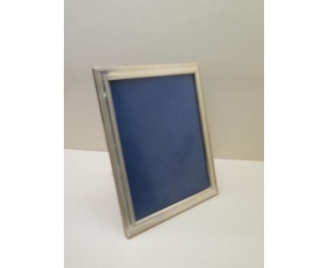 A silver presentation photo frame with mahogany easel back 28cm x 21cm, in good condition 
