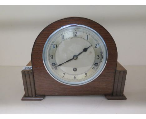 An oak case 8 day mantle clock by Garrard with Westminster chimes, 22cm tall, in running order 