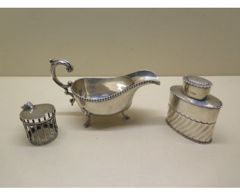 A silver caddy, London 1897/98 make J.H, 8.8cm, generally good, a silver mustard surround missing handle and some bending and