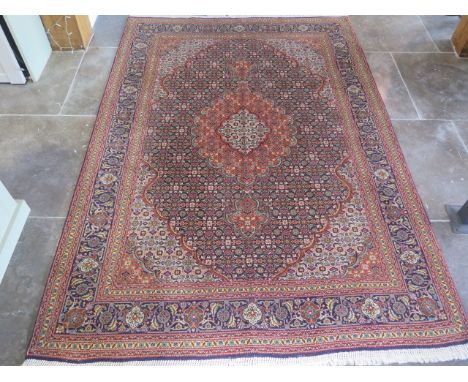 A hand woven woollen fine Tabriz rug, Mahi design, small worn patch but otherwise good, colours bright, 2.15m x 1.5m 