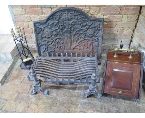 A cast iron fireback and grate with a mahogany coal scuttle and fire iron set, back 75cm x 85cm, grate and dogs are 42cm tall