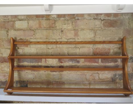 An Ercol blond elm plate rack, 49cm tall x 97cm wide x 13cm deep 