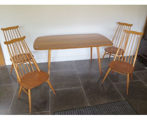 An Ercol dining table and 4 high back Ercol dining chairs in generally good condition apart from a split to end as per photog