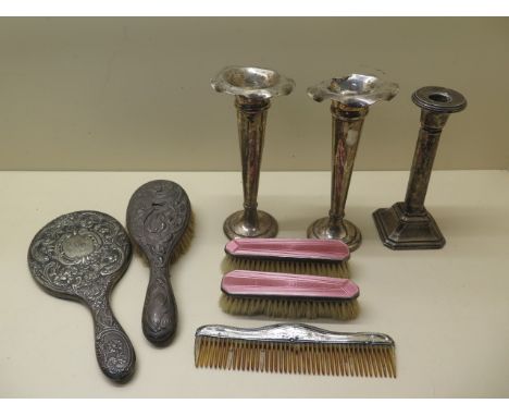 A pair of weighted silver vases, 20cm tall, a silver weighted candlestick, a silver back mirror, a brush, a comb and a pair o