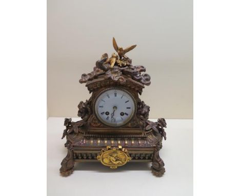 An ormulu striking mantle clock, 27cm tall x 24cm, running and strikes, some cracking to dial but generally good 