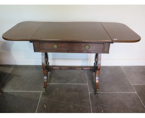 A late 19th century mahogany dropleaf stretcher table with an active and a dummy drawer on lyre end supports, 76cm tall x 60c