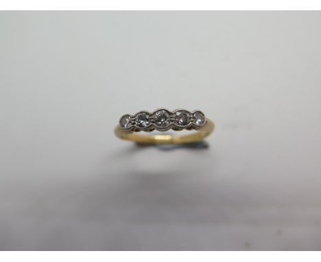 An 18ct five stone diamond ring, size K/L, hallmarked, diamonds bright, approx 2.1 grams, some wear otherwise good 