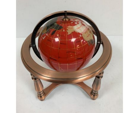 Red stone globe with compass 