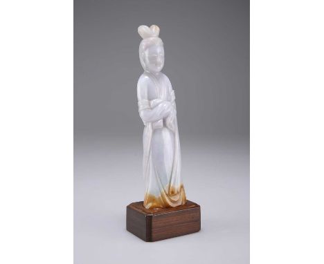 A CHINESE JADEITE STANDING FIGURE wearing a long-sleeved robe with sash, hair dressed in a chignon with double coil, arms hid