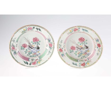 A PAIR OF 19TH CENTURY CHINESE FAMILLE ROSE BOWLS each painted with a pair of pheasants perched upon rocky outcrops, with peo