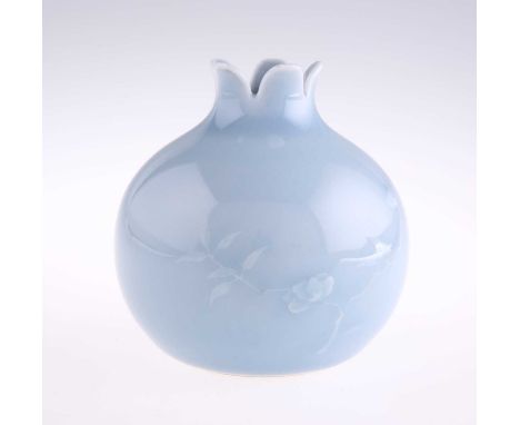 A CHINESE SKY-BLUE GLAZED POMEGRANATE VASE of globular form, decorated with two flowering branches in raised light slip, bear