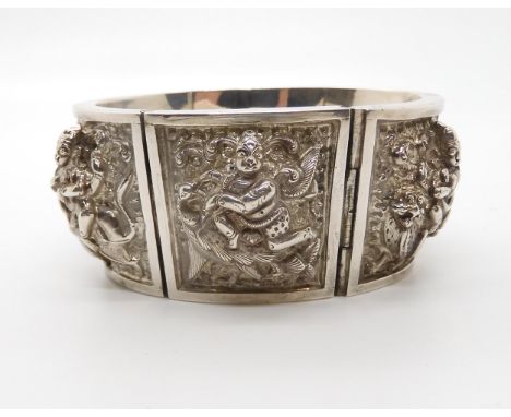 A white metal Indian hand repoussed and engraved&nbsp; bangle depicting Gods and Goddesses Condition report not available for