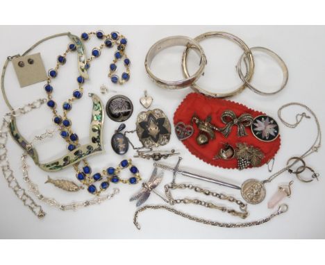 A collection of silver and costume jewellery to include an enamel dragonfly A condition report is not available for this lot.