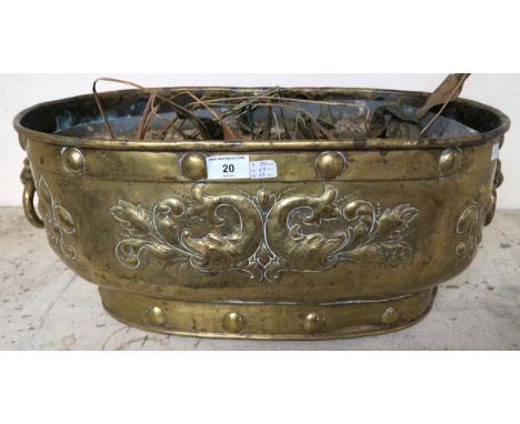 A Victorian oblong brass planter embossed with fish and fleur de lys with two lion mask ring handles,  26cm high x 65cm wide 