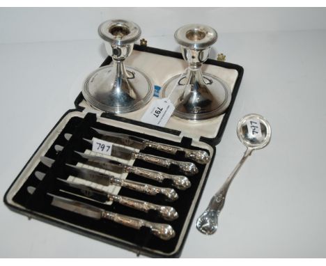 A lot comprising&nbsp; a pair of silver candlesticks, Birmingham 1919, a sauce ladle, Glasgow 1827 and a cased set of six sil