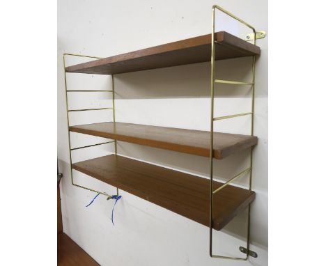 A brass and teak hanging wall shelf in the manner of Staples Ladderax, 60cm high x 60cm wide x 21cm deep Condition report: Av