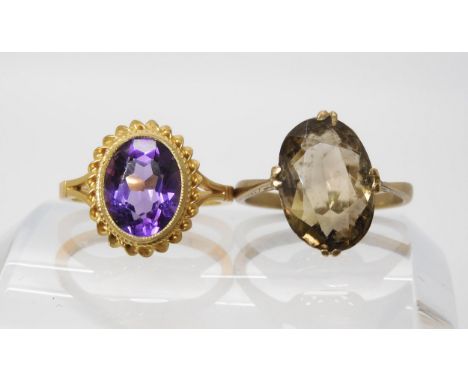 A 9ct gold amethyst set ring size L1/2, together with a smoky quartz set ring with decorative 9ct mount, size M1/2, weight 5.