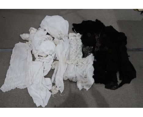A lot comprising a large selection of black lace fabric, black lace shawls, an embroidered lace blouse &amp; a large selectio