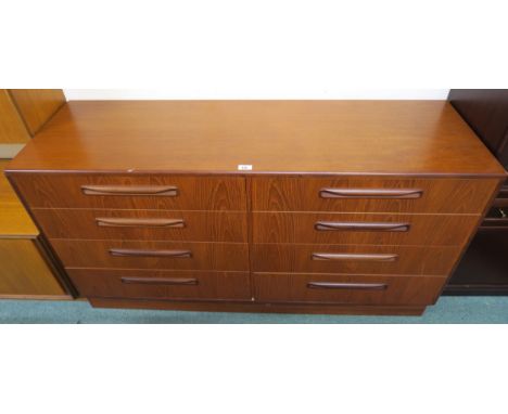 A mid 20th century stained teak G Plan bank of eight drawers, 76cm high x 142cm wide x 45cm deep Condition report: In fair ov