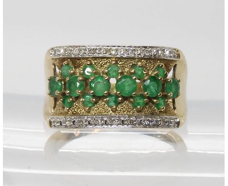 A 9ct wide band ring set with diamonds and emeralds, finger size R1/2, weight 4.2gms Light general wear