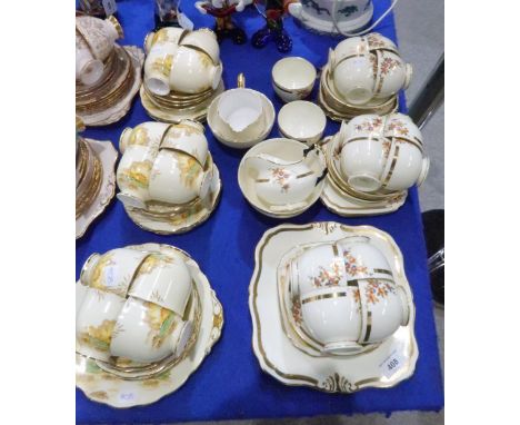 A Tuscan china teaset with floral decoration and a Roslyn China teaset with waterlily decoration Tuscan - one cup crackedRosl