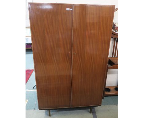 A mid 20th century teak Lebus compactum wardrobe, 180cm high x 108cm wide x 66cm deep Condition report: Available upon reques