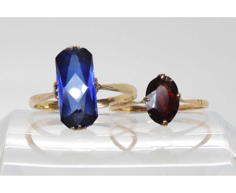 A 9ct gold garnet ring, size R1/2, together with a fancy cut blue glass gem set ring the shank marked GOLD, size T1/2, weight