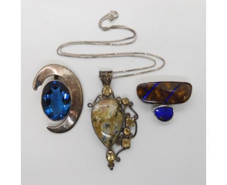 A silver opal matrix pendant, a silver ocean jasper and citrine pendant with chain. and a silver blue gem set pendant signed 