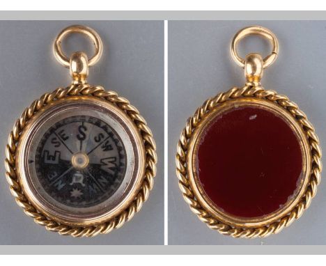 A 9CT YELLOW GOLD FOB AND COMPASS, of circular form with rope frame, one side set with carnelian, the other with compass, 3.5