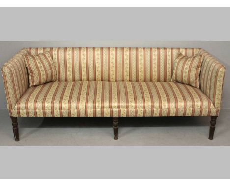 A REGENCY MAHOGANY SOFA, the rectangular back, sides and seat upholstered in a Regency stripe, standing on six turned taperin