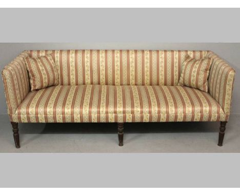 A REGENCY MAHOGANY SOFA, the rectangular back, sides and seat upholstered in a Regency stripe, standing on six turned taperin