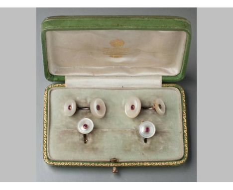 A 19TH CENTURY CONTINENTAL SET OF MOTHER-OF-PEARL AND RUBY CUFFLINKS AND COLLAR STUDS, of circular form with central ruby, ma