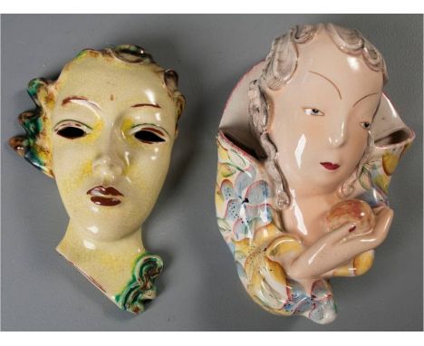 A GOLDSCHEIDER TERRACOTTA ART DECO WALL VASE/MASK, of a lady holding an apple, flanked by twin vases hand-painted with blue a