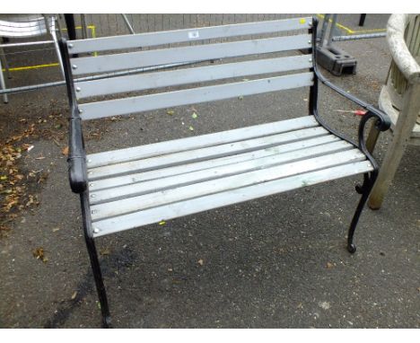A PAINTED GREY GARDEN BENCH WITH CAST ENDS