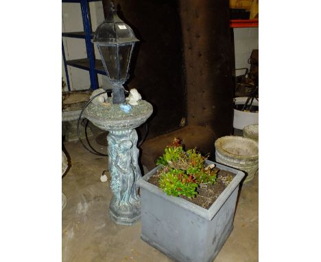 A LARGE SQUARE PLANTER PLUS CONTENTS TOGETHER WITH A FIGURATIVE GARDEN LAMP