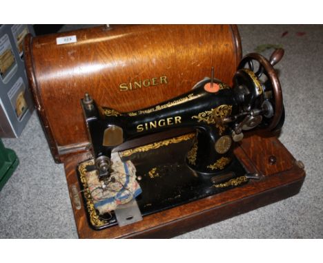 A CASED VINTAGE SINGER SEWING MACHINE