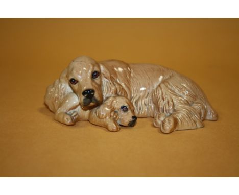 A ROYAL DOULTON CERAMIC FIGURE OF A DOG WITH ITS PUPPY  