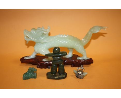 A MODERN ORIENTAL JADE CARVING OF A DRAGON, TOGETHER WITH THREE SMALLER EXAMPLES (DRAGON LENGTH- -28CM  (4)