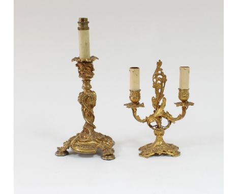 A French 19th Century ormolu twin-branch candelabrum in the Rococo style with scrolling acanthus leaf branches, on a shaped s