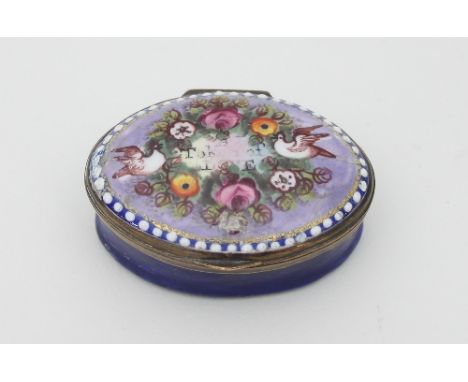 An early 19th Century oval blue enamel patch box, the hinged cover decorated with birds and flowers and 'A Token of Love' wit