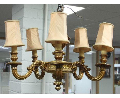 A giltwood five-light electrolier with carved surmount