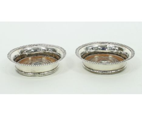 A pair of George III silver decanter coasters, marks rubbed, London 1810, with gadrooned edges, 17.5cm diameter  Condition Re