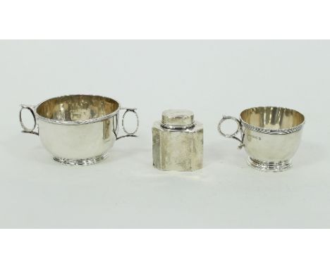 A small rectangular silver tea caddy, London 1897 with canted corners and oval cover, 5.5cm wide, a silver porringer, marks r